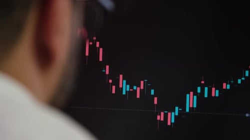 Stockbroker Looking At Stock Market Charts