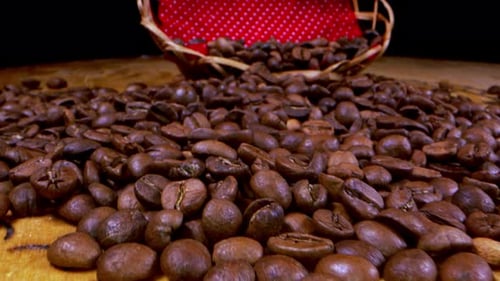 Roasted Coffee Beans Piled on a Wooden Table