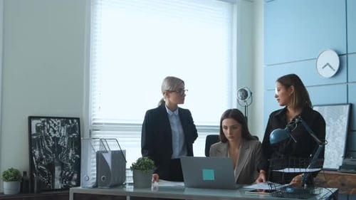 Women are discussing a new project in business and they are in the office