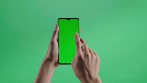 A Hand Touching Green Screen Smartphone On The Green Screen Background