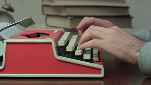 Close Up of Hands Typing on Typewriter