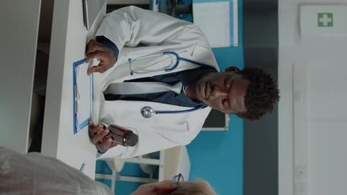 Friendly Doctor Discusses Medication With Patient