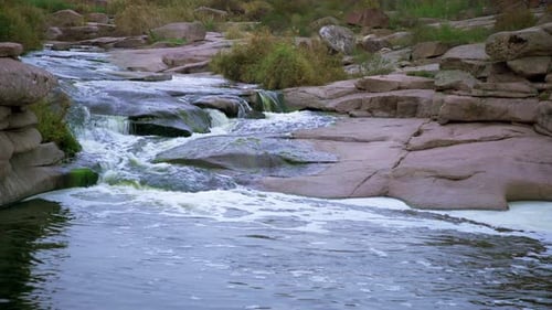 A Small Shining Stream Flows Among Smooth Wet and Dark Stones