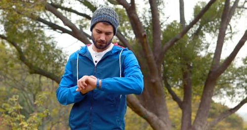 Young Man Waits in Park, Checks Watch