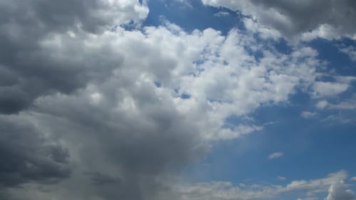 Clouds Moving Across a Bright Blue Sky