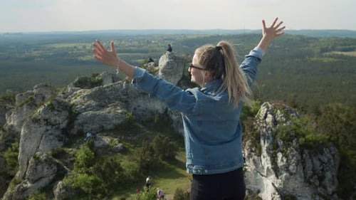 Young Woman Celebrating on Mountain Peak