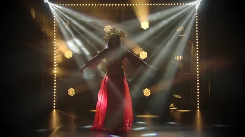 Woman Dances in Red Dress Under Spotlights