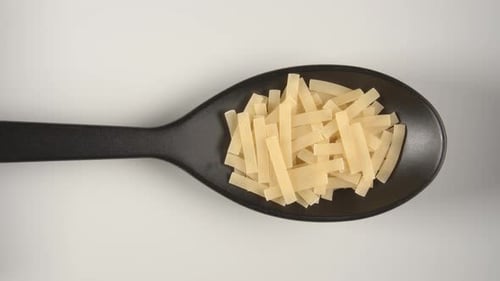 Pasta Filling a Black Spoon