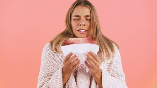 Sick Woman Wipes Her Nose with a Tissue
