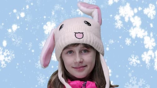 Girl in Bunny Hat Smiling in Winter Scene