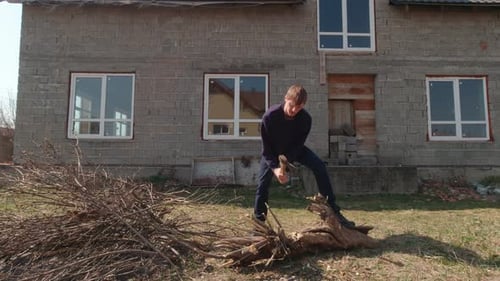 Man Cutting A Log