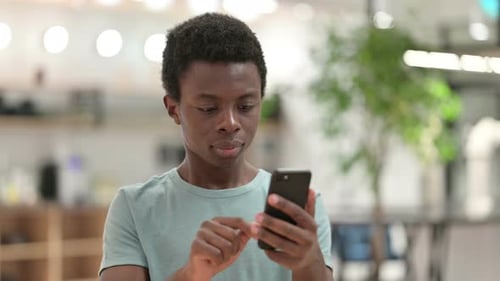 Happy Young Adult with Phone