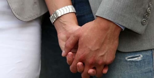 Couple Holding Hands in Close Up Detail