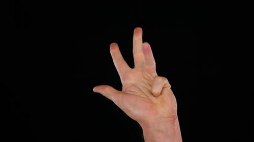 Hand Counting Digits Against a Black Background