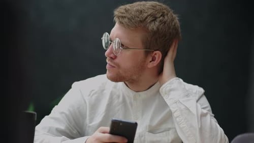 Young Adult Using Phone in Workplace