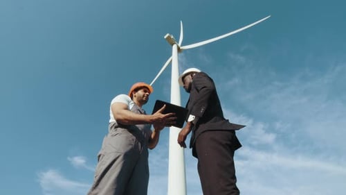 Engineer and Inspector Working Together on Windmill Farm