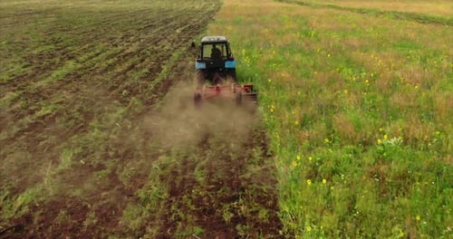 Tractor Plows the Field Removes Weeds