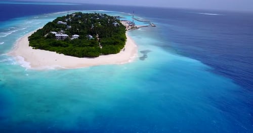 Wide aerial island view of a white sand paradise beach and aqua turquoise water background