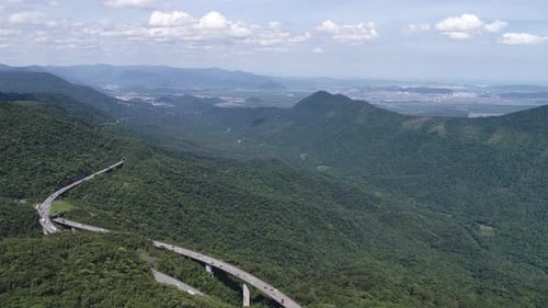 Construction landscape of highway road between green mountains.