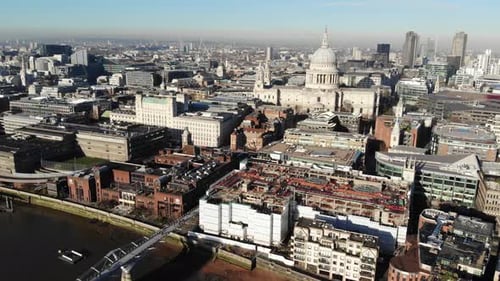 Aerial shot of St Pauls Cathedral and Millennium Bridge on a hazy sunny day