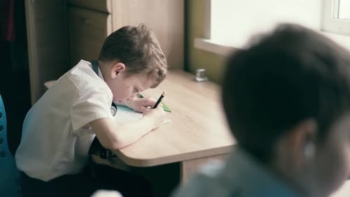 Stedicam Children Sit in Headphones and Do School Homework