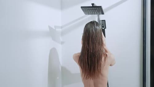 Woman Washing Long Brown Hair in Modern Shower