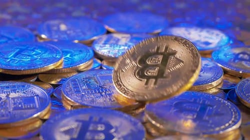 Bitcoin Falling in Blue and Gold Close Up