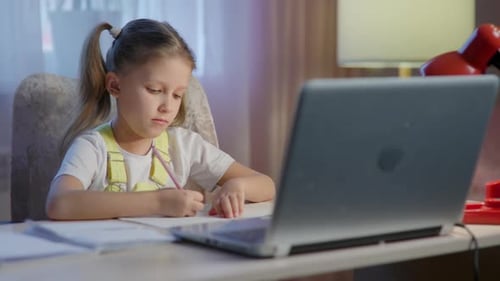 Girl Doing Homework at Desk with Laptop