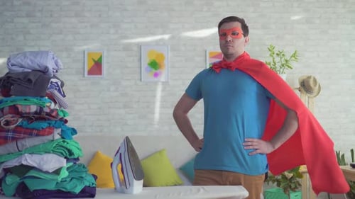 Man in Superhero Costume Poses with Laundry