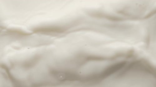 Square Chocolate Falling Into Melt Yogurt and Making Crown and Circular Ripples