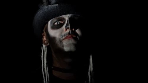 Creepy Man with Skeleton Makeup Appearing From Darkness When Light Falls on Him, Making Faces