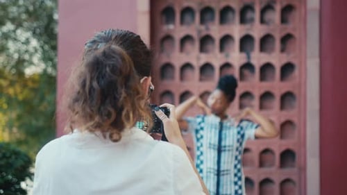 Model Posing for Photographer in Urban Setting