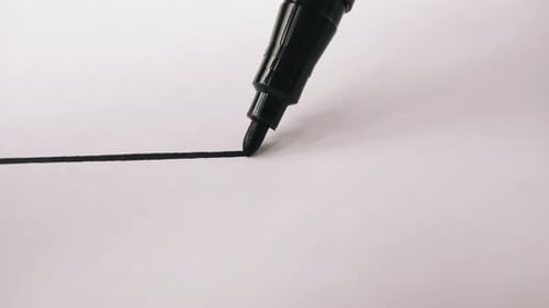 Marker Draws a Line on White Paper