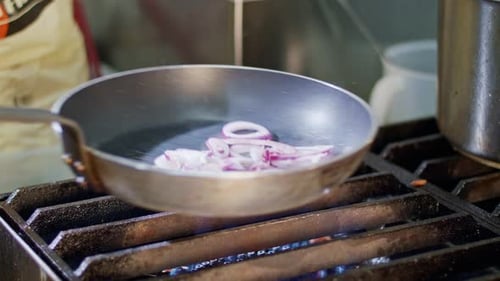 Red Onions Sizzle in a Frying Pan