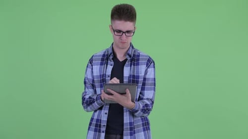 Young Adult Using Tablet and Thinking