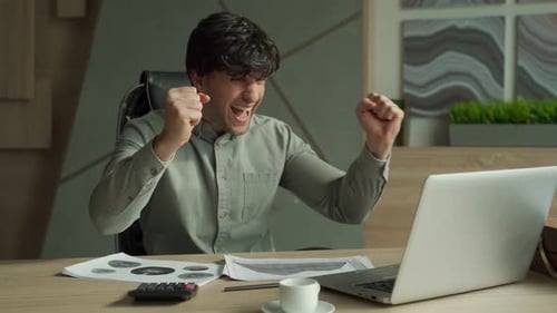 Excited Man Working at Computer with Falling Money
