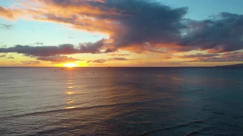 Picturesque Hawaiin Ocean Sunrise Over The Surfing Beach Of Waikiki In Honolulu. Group of Surfers an