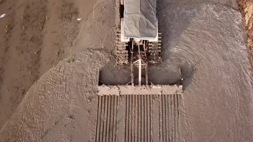 Aerial close up tractor plowing the soil for cultivation