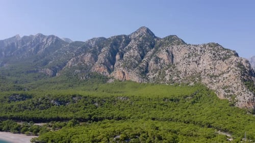 High Rocky Mountains on Blue Sky Background