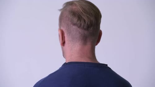 Rear View Head Shot of Blonde Man Looking Back