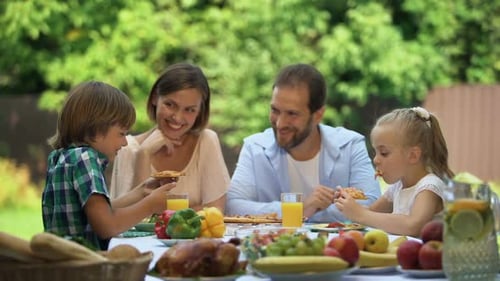 Family Enjoying Lunch Together Outdoors