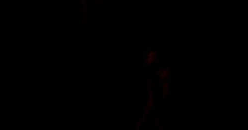 Man Breathing Fire in the Dark Night