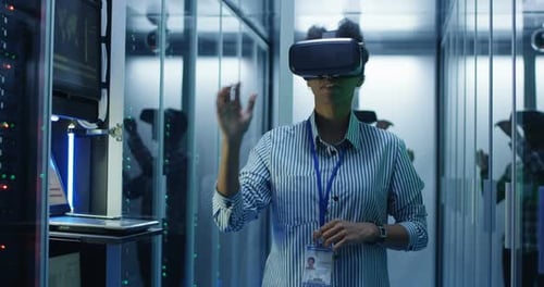 Ethnic Woman in VR Glasses Working in Data Center