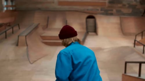 Skateboarder Riding in Indoor Skatepark