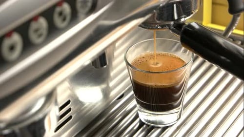 Fresh Espresso Pouring From Espresso Machine Into Glass