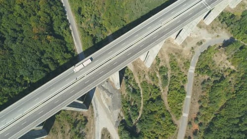 Top View of Highway Bridge with White Truck Driving Along