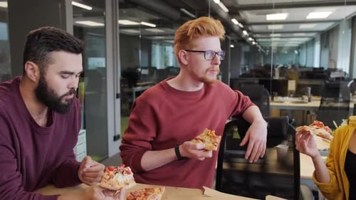 Office Workers Eating Pizza Indoors