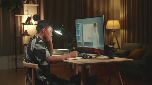 Bored Asian Boy Student Distance Learning With Online Teacher On Computer Screen From Home