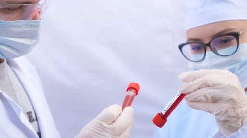 Medical Professionals Analyzing COVID-19 Blood Samples