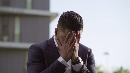 Worried Man in Suit in Urban Setting